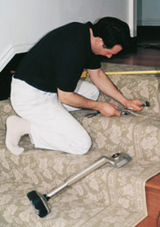 Installer expertly setting up a staircase carpet.